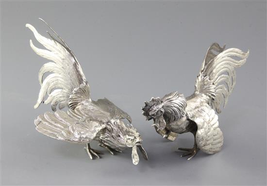 A pair of early 20th century German 800 standard silver model fighting cocks, 12 oz.
